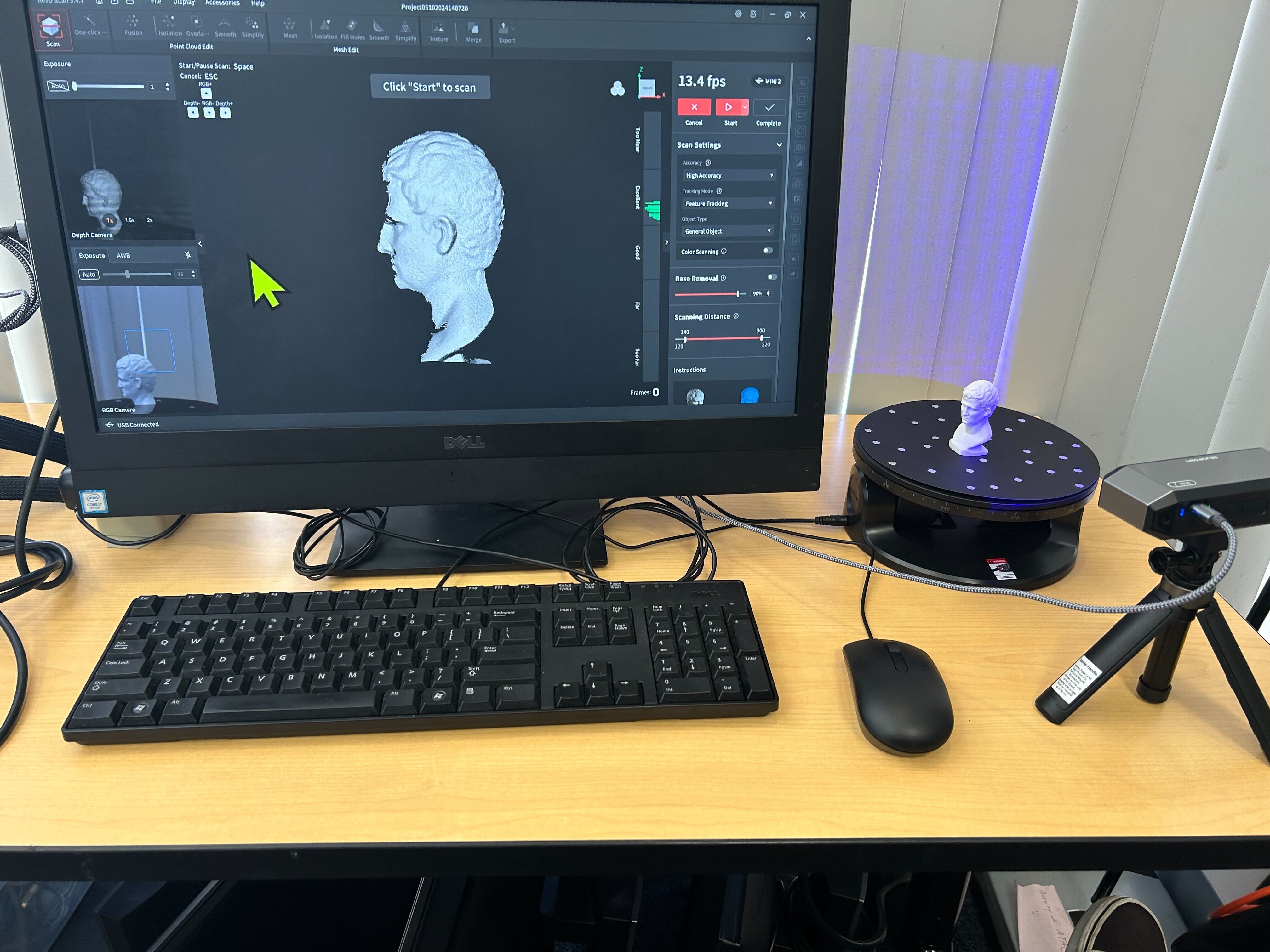 Holding a fossil with several 3d printed copies in the background